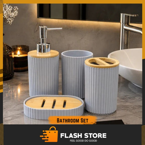 Bathroom accessory set with dispenser, cups, and soap dish on a marble countertop.
